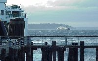 A late afternoon view of a ferry and choppy water.